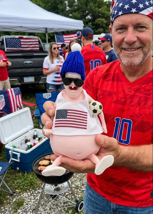 Man holding a toy with an American flag design at a sports event.