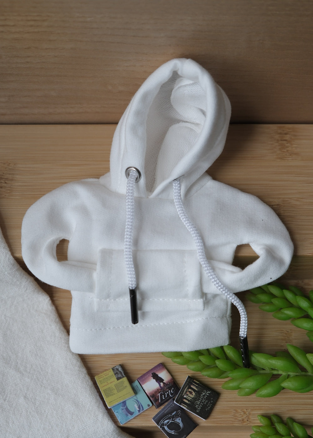 A deformable toy resembling a student wearing a hoodie, beanie, sunglasses, and carrying a backpack with miniature books.