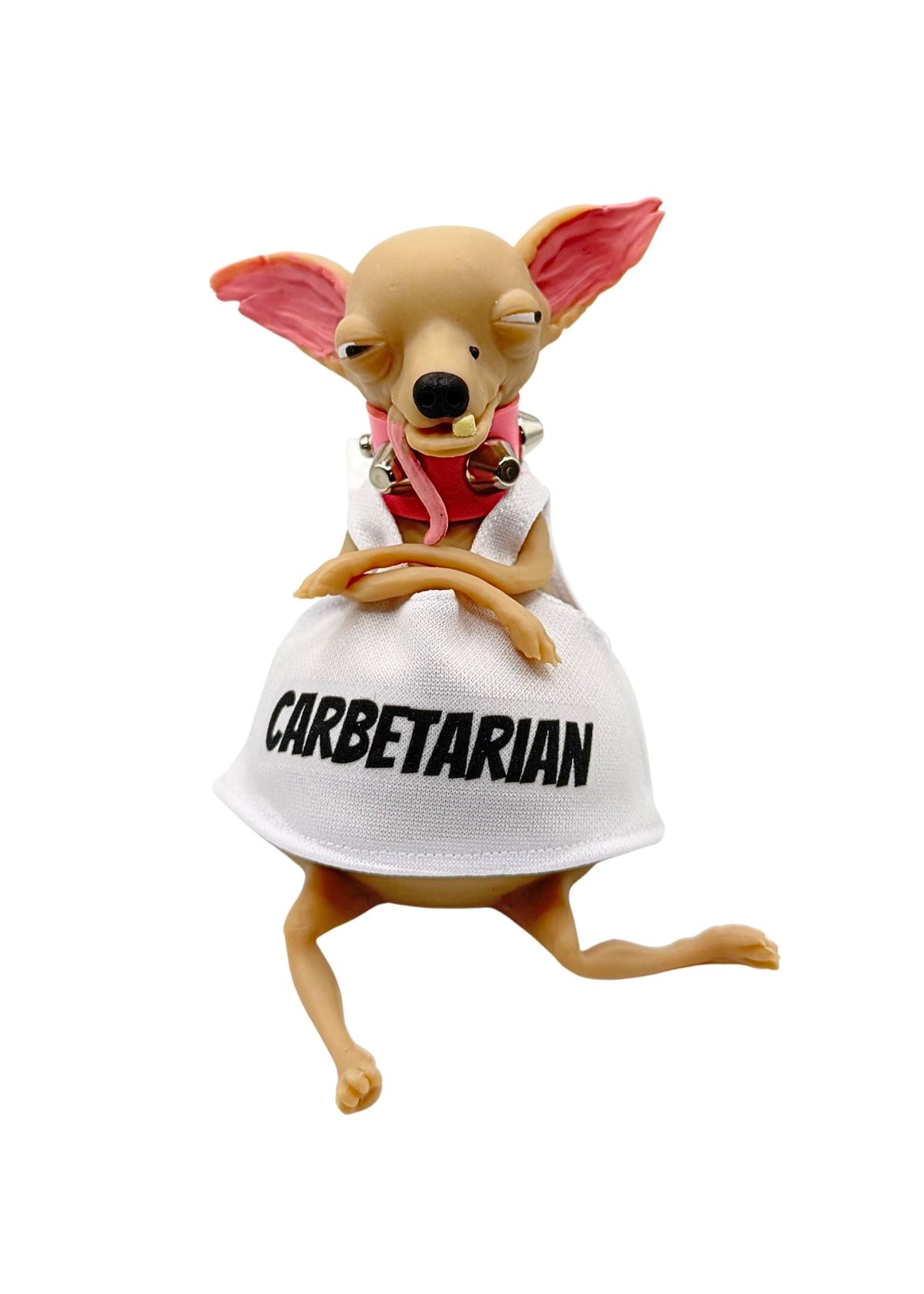 A small figurine of a tan Chihuahua wearing a white shirt and a white apron with the word 'CARBETARIAN' printed in black, posed sitting on a white sack against a plain white background.