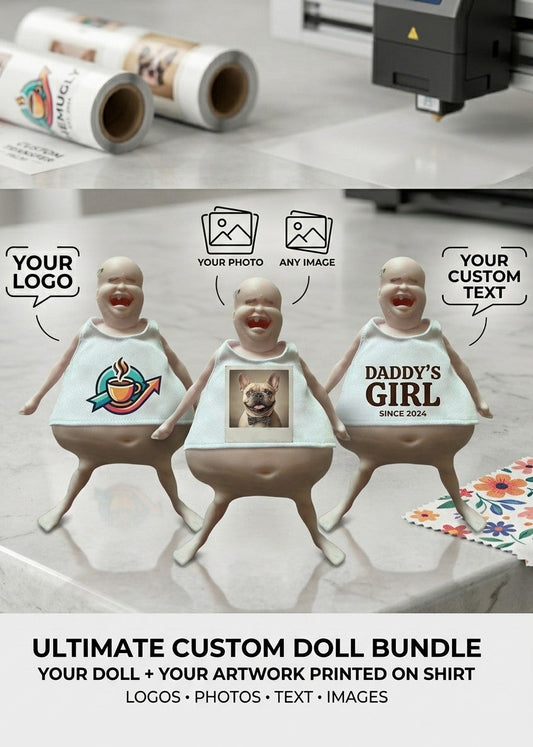 Three custom plastic baby dolls with printed shirts are displayed on a marble countertop alongside printed rolls of material and a crafting machine. The shirts feature custom designs including a colorful logo, a dog photo, and 'DADDY'S GIRL' text.