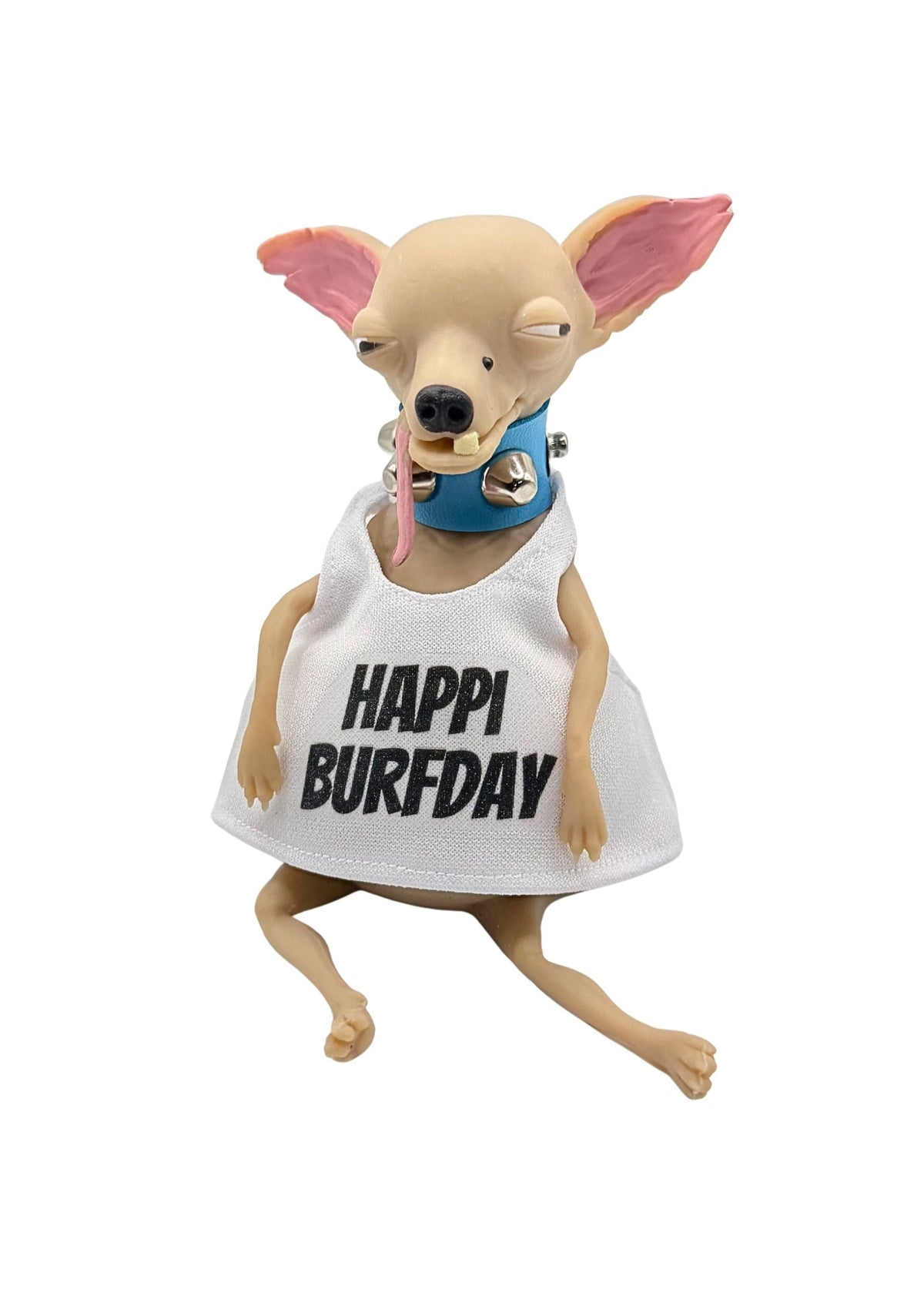 A small tan dog figurine wearing a white sleeveless dress with the words “HAPPI BURFDAY” in black text and a blue collar, shown on a plain white background.