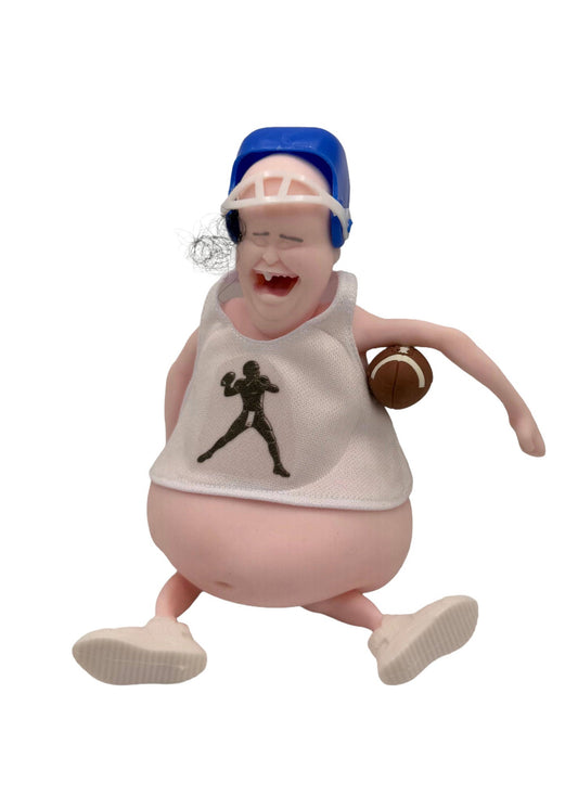 A novelty collectible figurine of a cartoonish overweight football player running, wearing a white tank top with a black football player silhouette, a blue helmet, and holding a brown football.