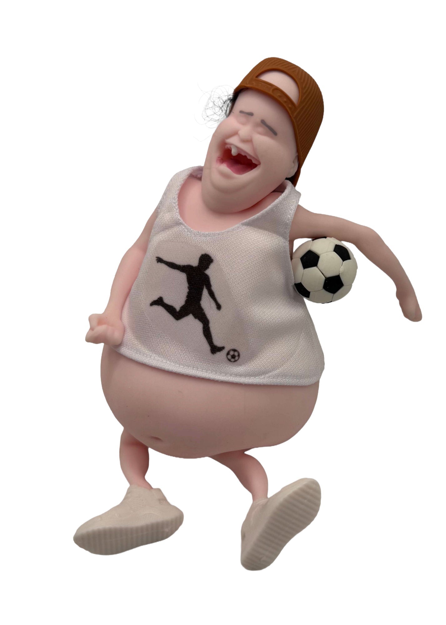 A novelty collectible figurine of a cartoonishly obese man wearing a brown backward cap, a white tank top with a black soccer player graphic, and beige shoes, holding a black and white soccer ball against a plain white background.